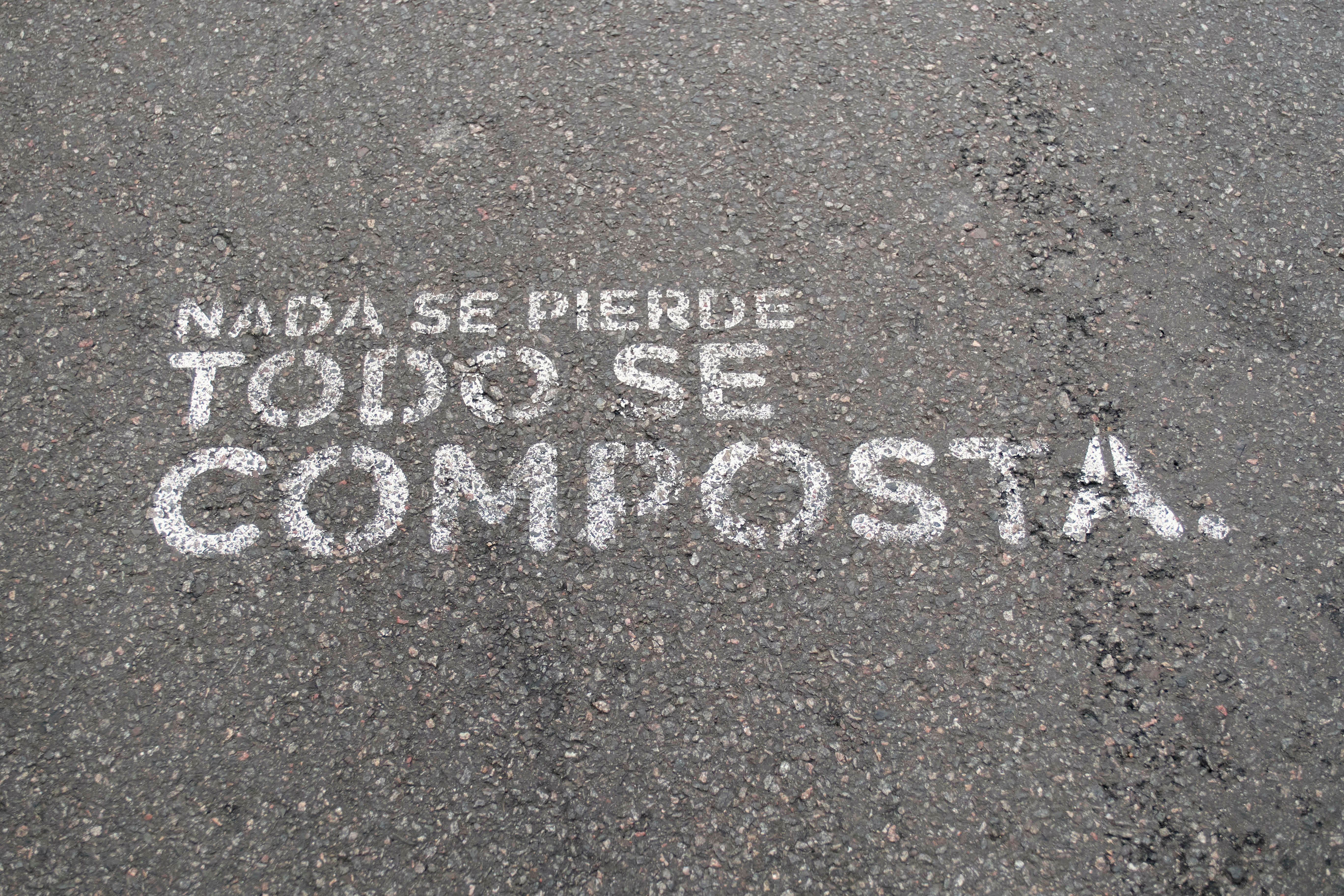 A message written on a street says, 