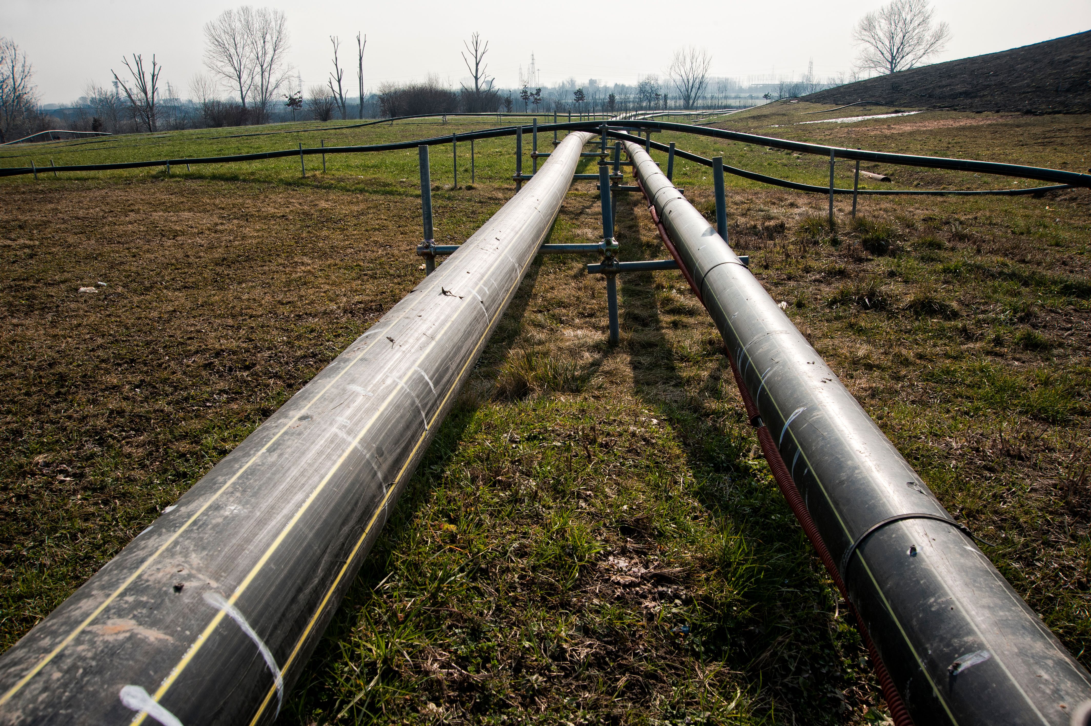 Two natural gas distribution pipelines passing through a field.
