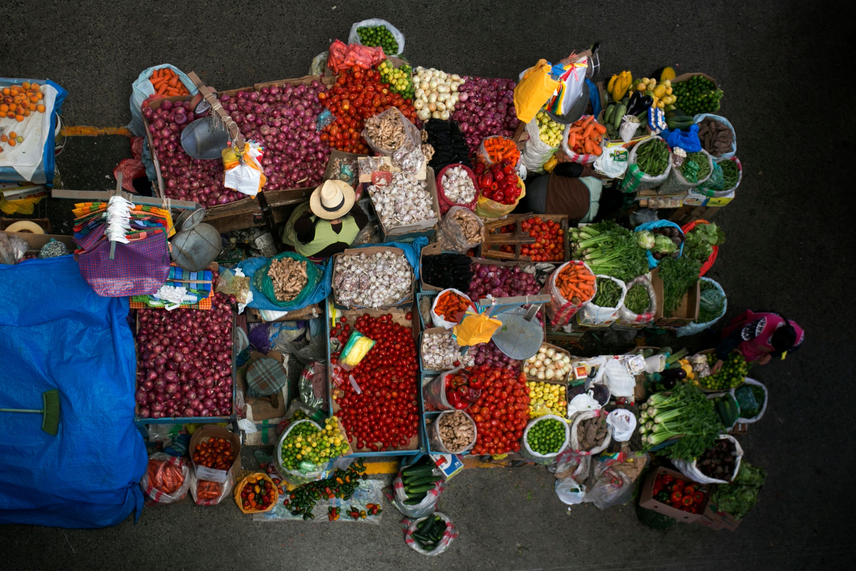 Bird's eye view of vegetable vendors at a market in Urubamba, Peru.